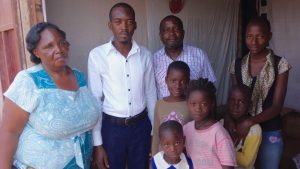 Pastor Lutaya and Moses with some church members. The woman at the left of the photo provided Pr Lutaya the building which now houses their gospel services each week.
