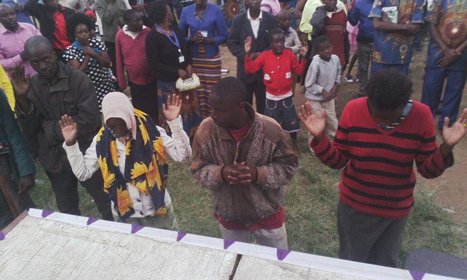 people-gather-around-the-stage-as-they-hear-about-gods-love