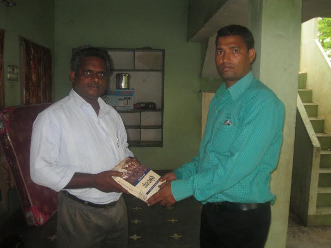Pr Daniel receiving the Jesus Only books from Pr Joseph
